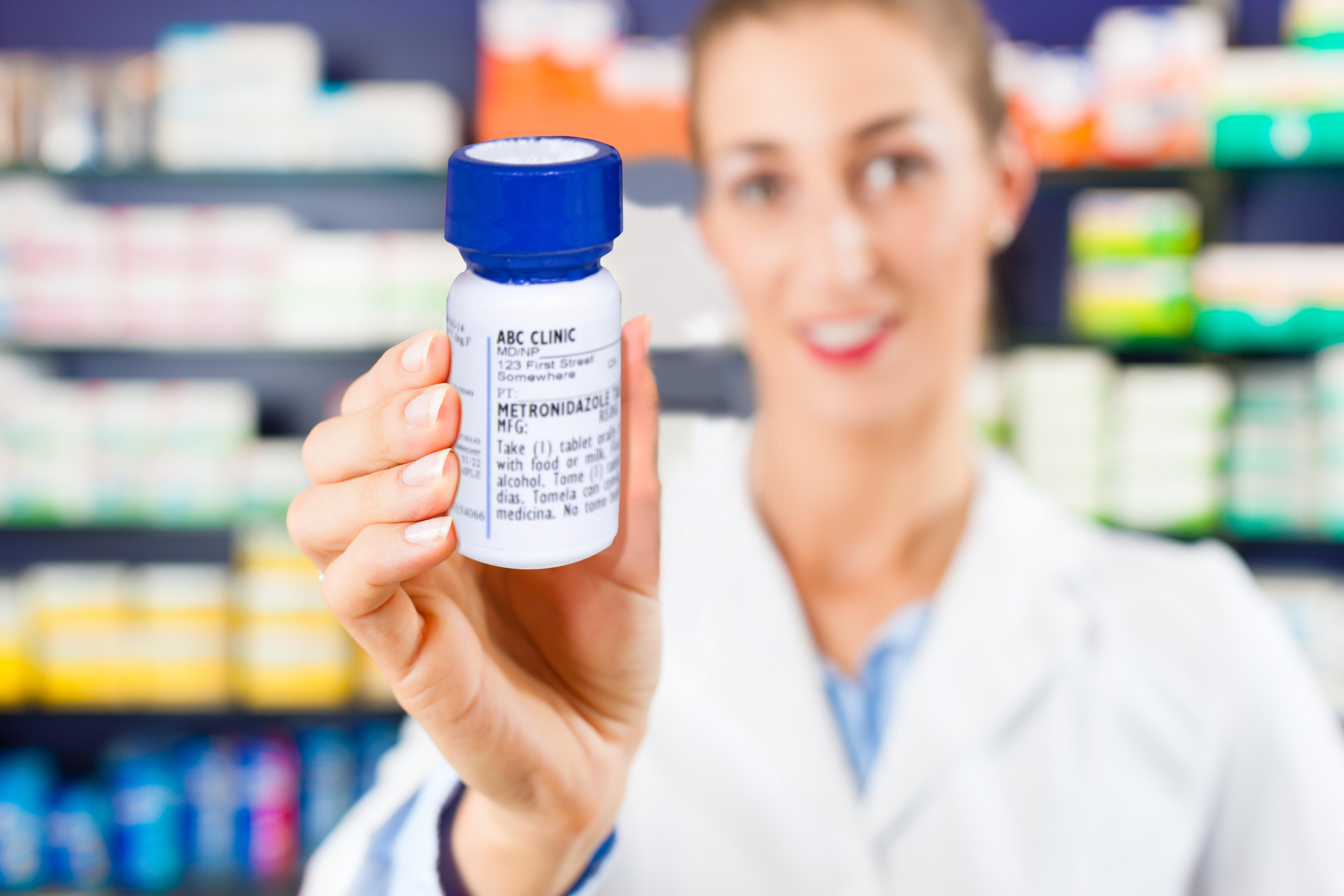 pharmacist holding a pharmpak bottle